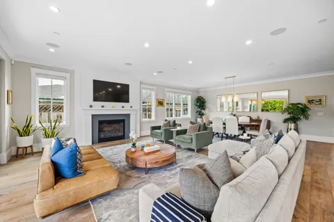 a living room with furniture a fireplace and a large window