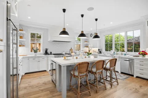 a kitchen with center island and stainless steel appliances