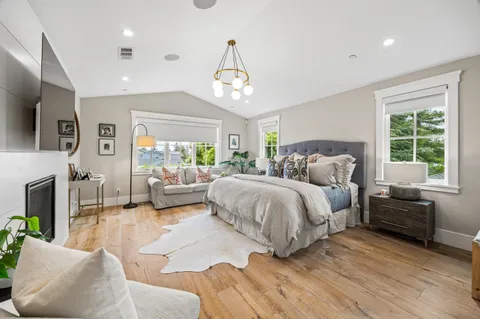 a spacious bedroom with a bed couch table and a window