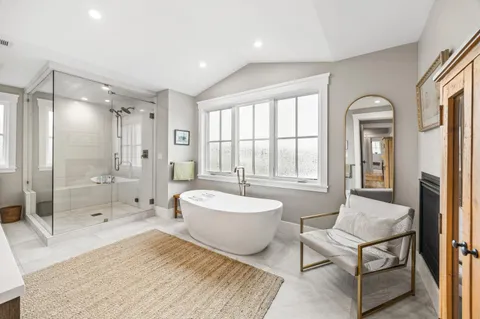 a spacious bedroom with a bed and a chandelier