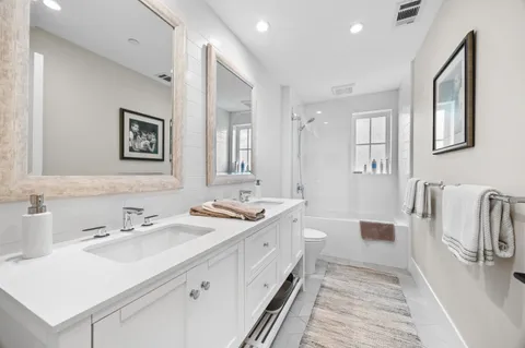 a spacious bathroom with a double vanity sink mirror and