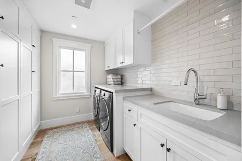 a kitchen with a sink cabinets and window