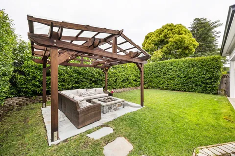 a backyard of a house with table and chairs