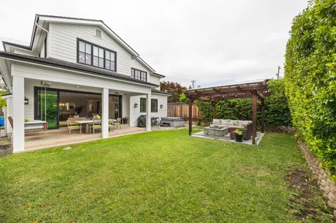 a view of a house with sitting area and garden