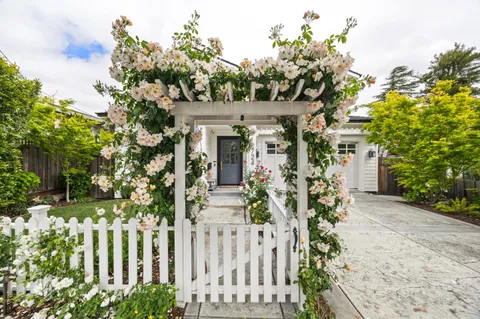 a view of a house with a flower garden