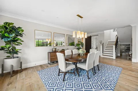 a dining room with furniture and wooden floor