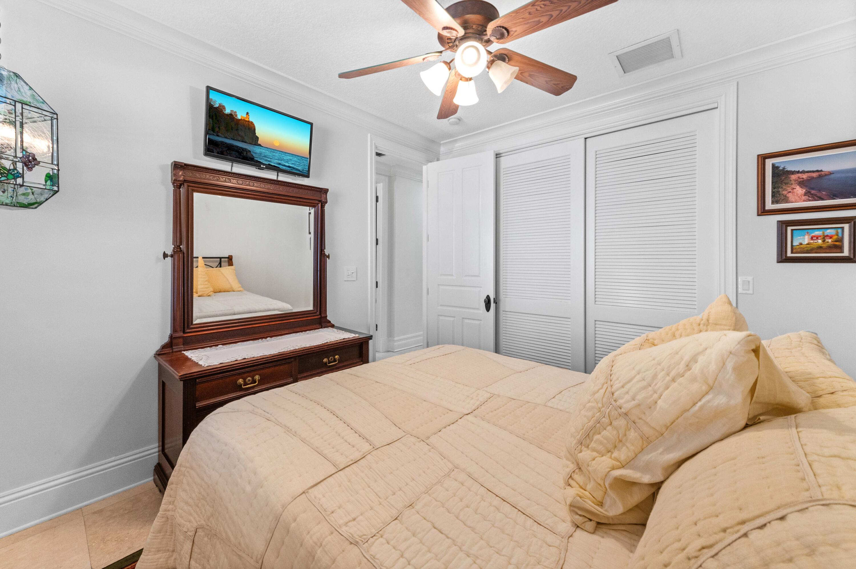 746 West Palmetto Park Road Boca Raton, FL 33486 - Photo 31 of 60 a bedroom with a bed and a chandelier