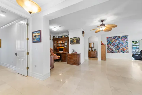 a dining room with furniture and a painting on the wall