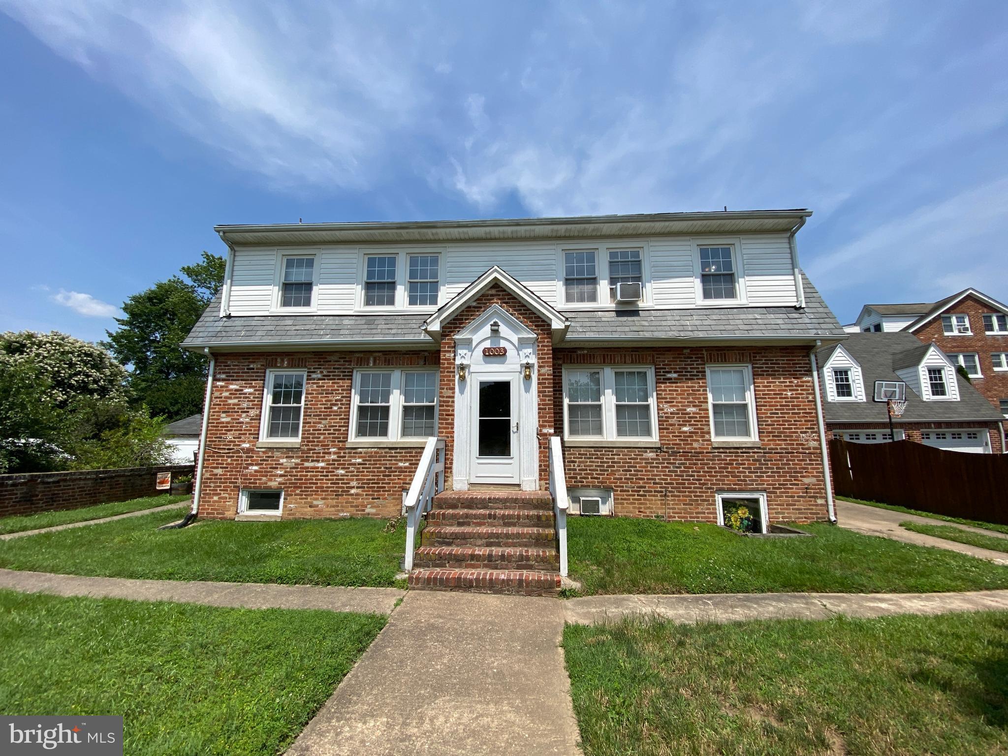 1003 Kenmore Avenue, Unit 3 Fredericksburg, VA 22401 - Photo 1 of 16 a front view of a house with a yard and garage