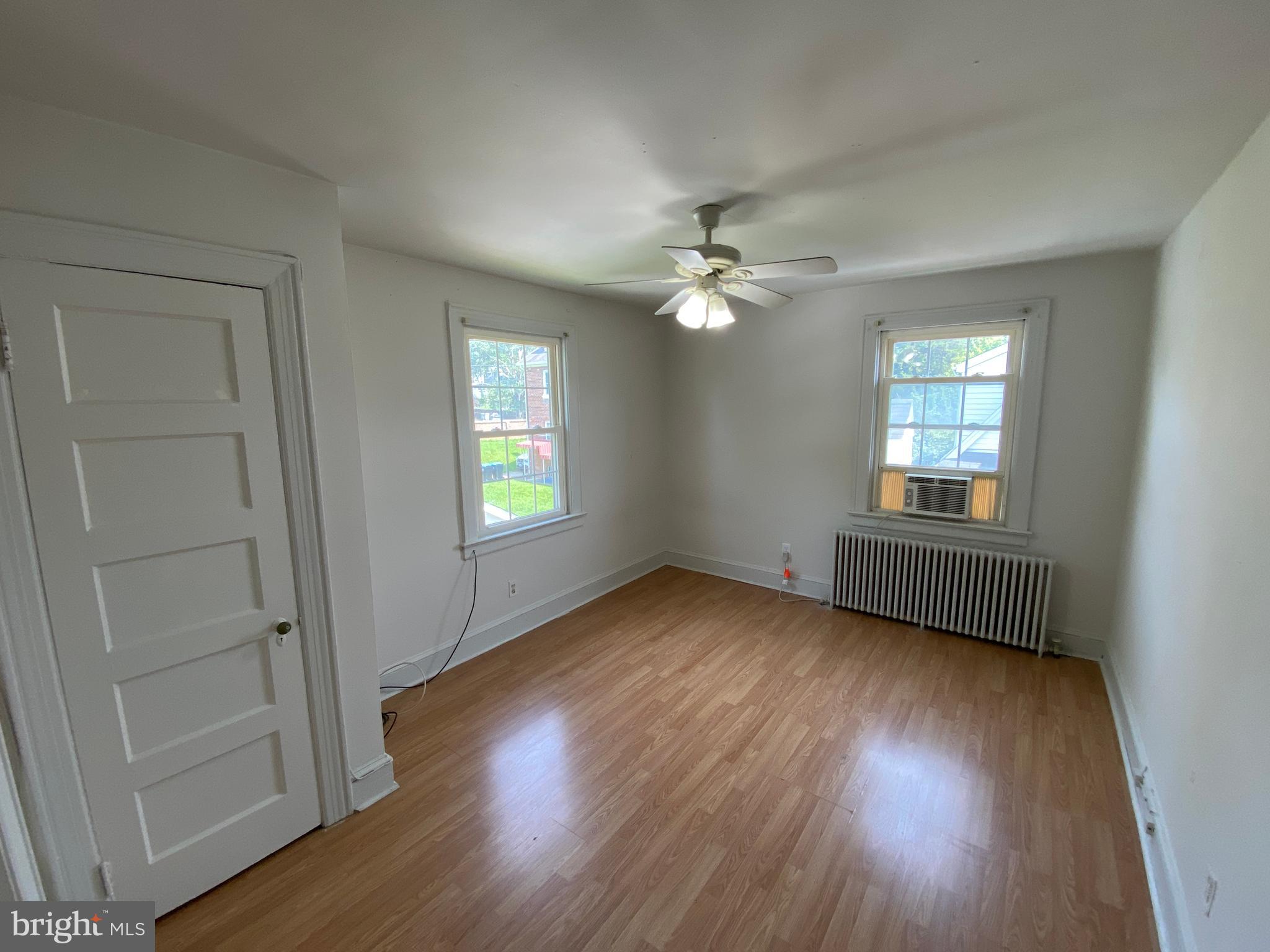 1003 Kenmore Avenue, Unit 3 Fredericksburg, VA 22401 - Photo 12 of 16 an empty room with wooden floor and windows