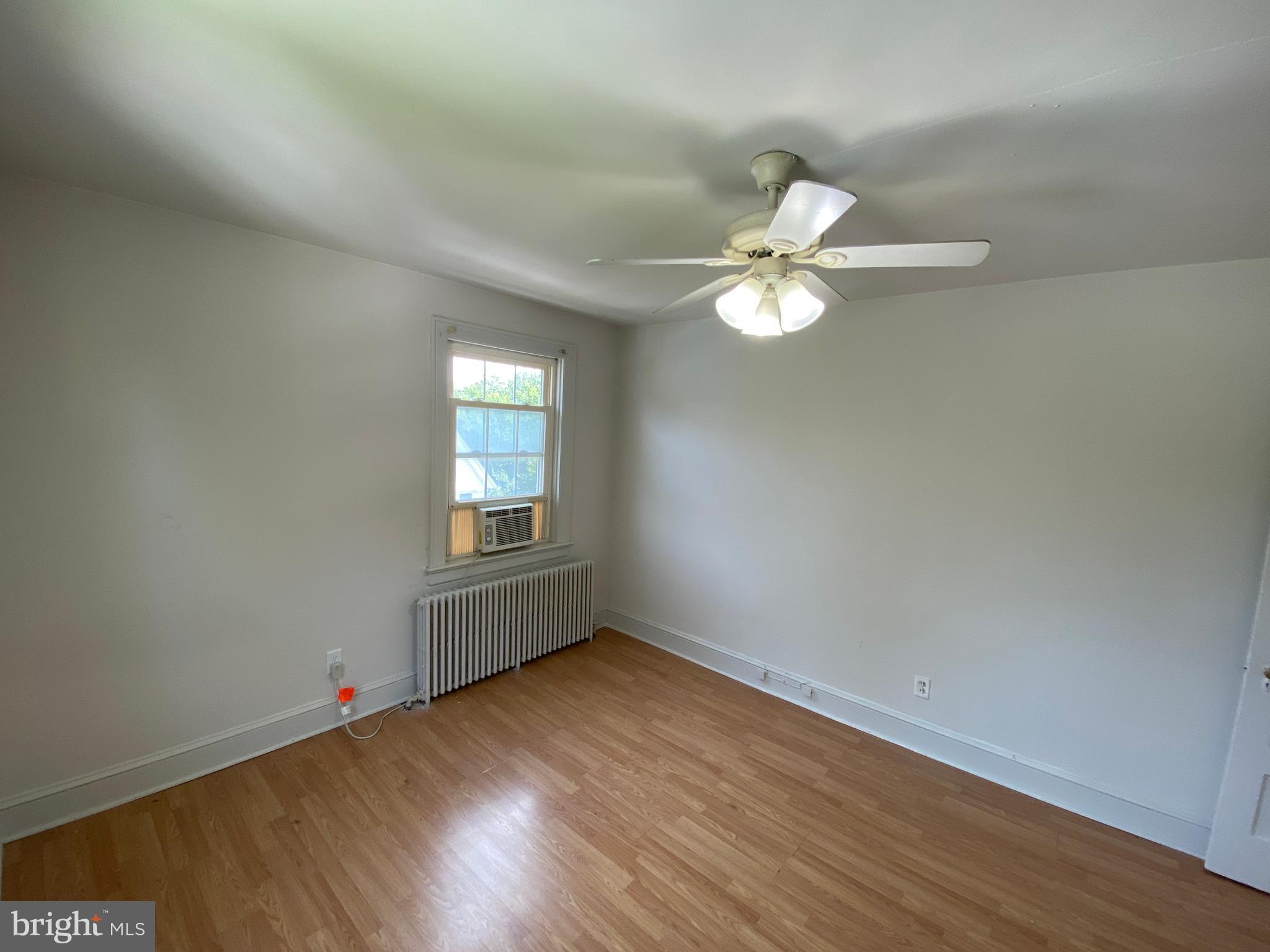 1003 Kenmore Avenue, Unit 3 Fredericksburg, VA 22401 - Photo 15 of 16 an empty room with wooden floor and window
