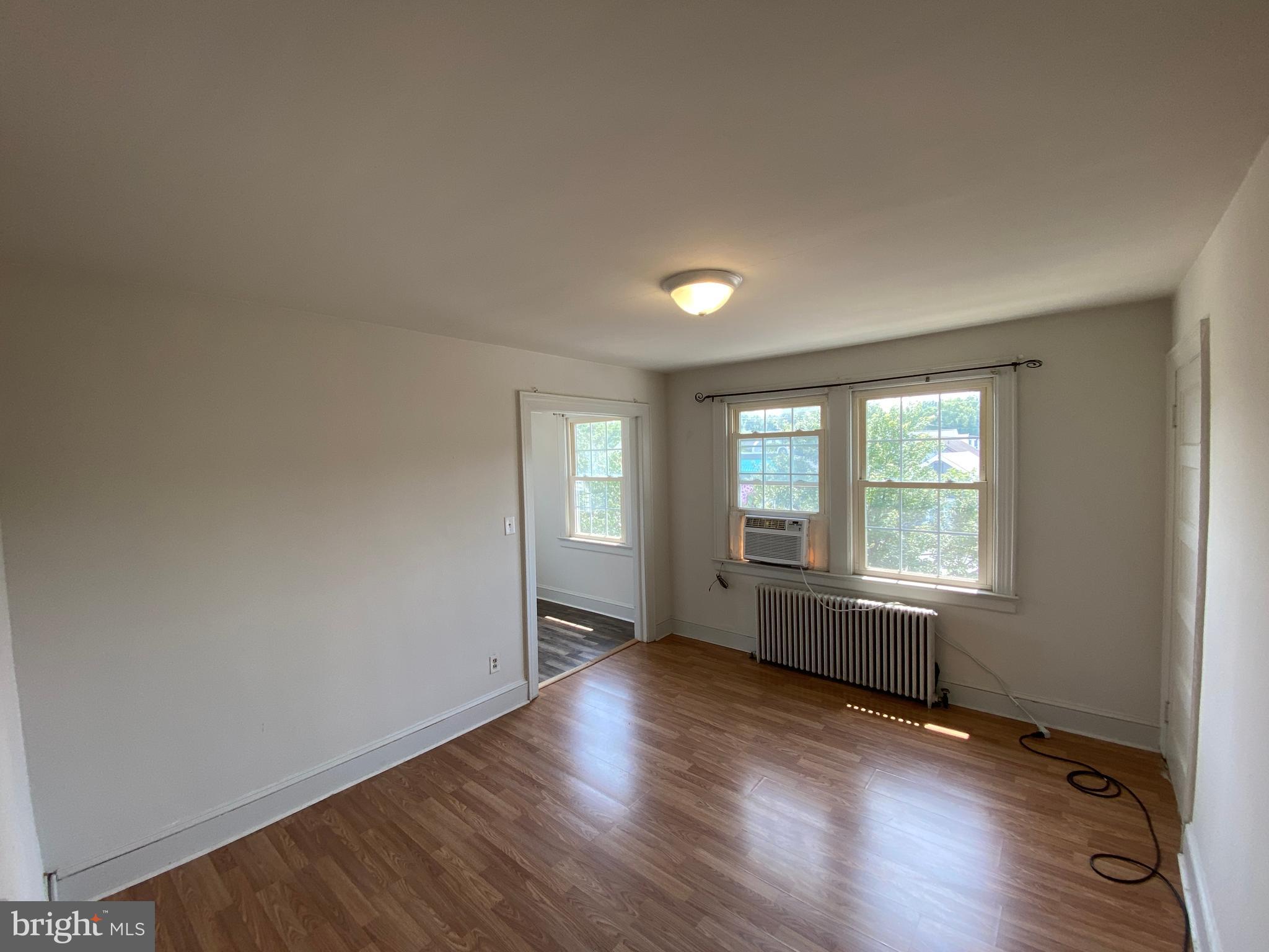 1003 Kenmore Avenue, Unit 3 Fredericksburg, VA 22401 - Photo 4 of 16 an empty room with wooden floor and windows