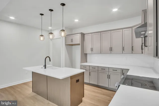 a kitchen with a sink counter and cabinets