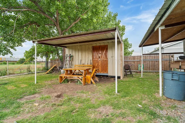 a view of a backyard with table and chairs