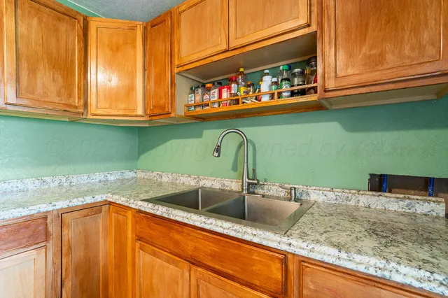 a kitchen with stainless steel appliances granite countertop a sink and cabinets