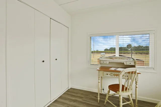 a view of a room with a table and chairs