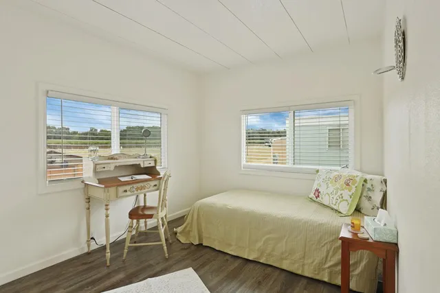 a bedroom with a bed and a table