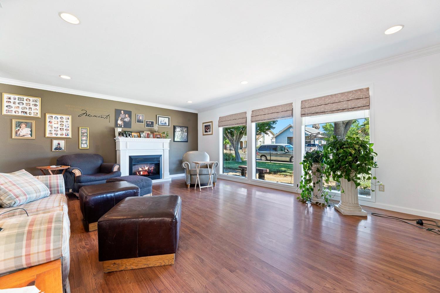 305 Monroe Street Coalinga, CA 93210 - Photo 11 of 53 a living room with furniture a fireplace and a large window