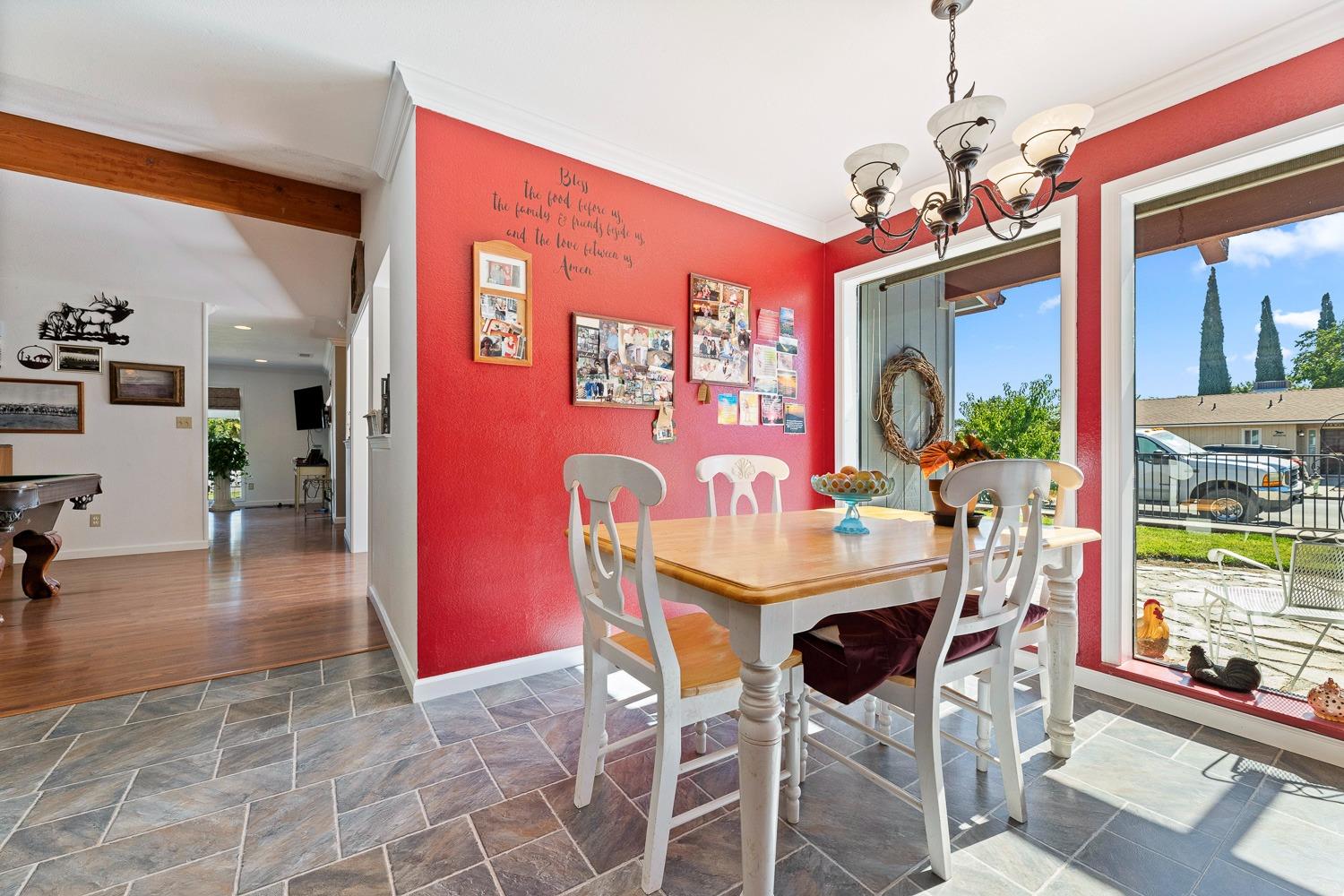 305 Monroe Street Coalinga, CA 93210 - Photo 20 of 53 a view of a dining room with furniture a chandelier and wooden floor