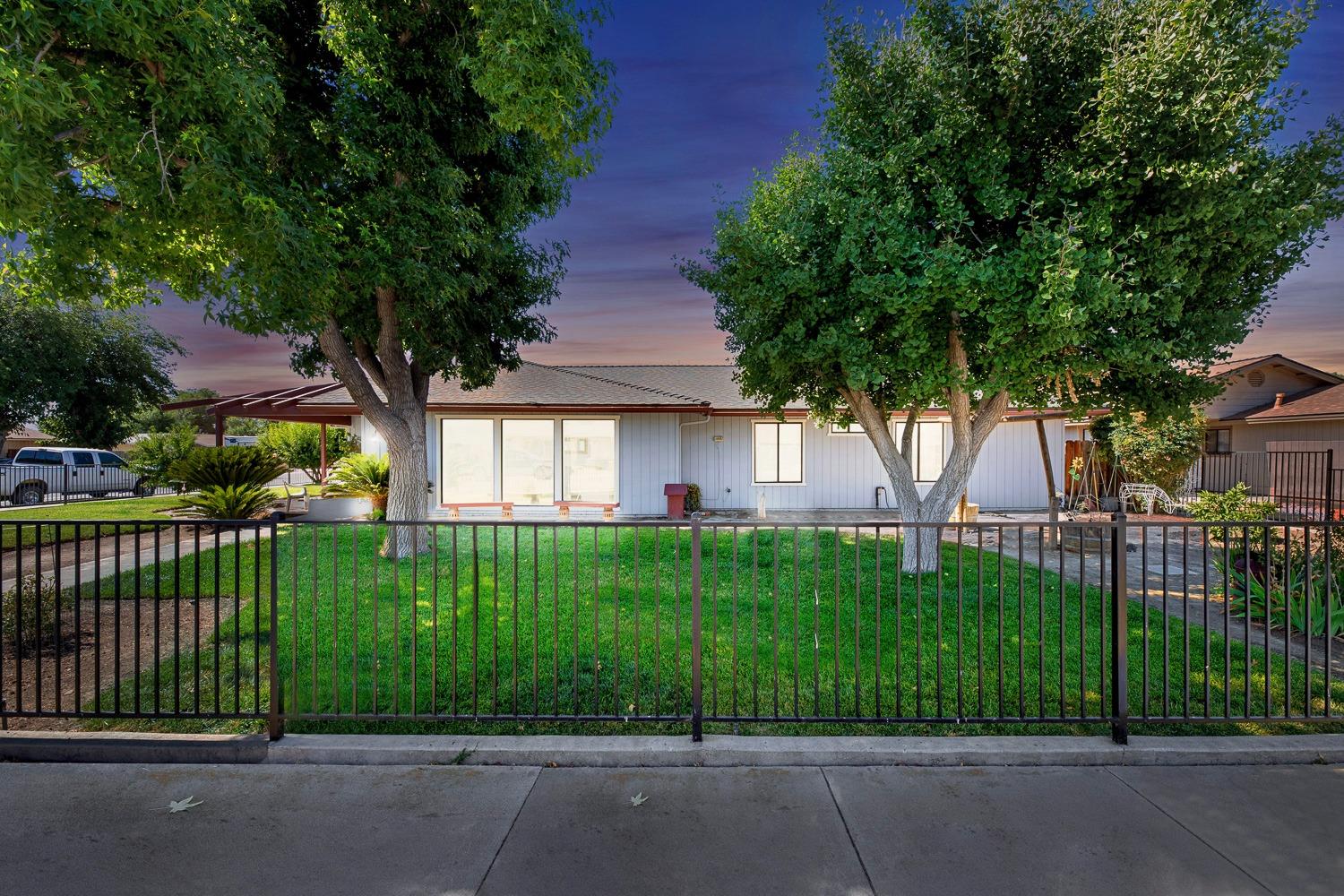 305 Monroe Street Coalinga, CA 93210 - Photo 2 of 53 a front view of a house with a garden and plants