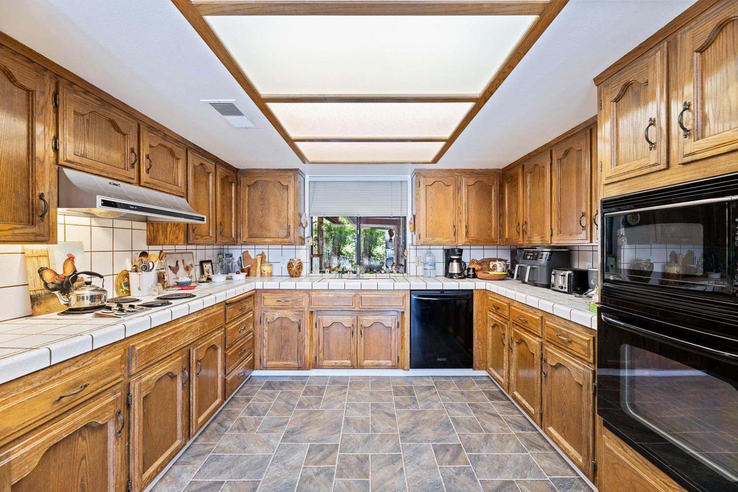 305 Monroe Street Coalinga, CA 93210 - Photo 22 of 53 a large kitchen with stainless steel appliances granite countertop a stove cabinets sink and dishwasher
