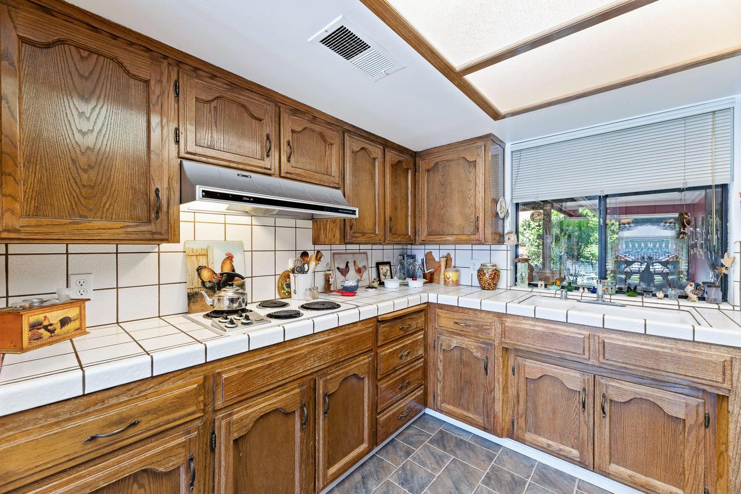 305 Monroe Street Coalinga, CA 93210 - Photo 23 of 53 a kitchen with a sink cabinets and window