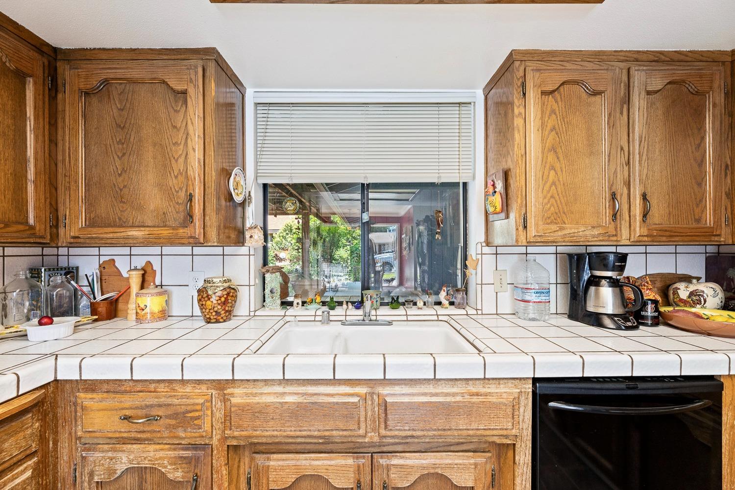 305 Monroe Street Coalinga, CA 93210 - Photo 25 of 53 a kitchen with a sink and cabinets
