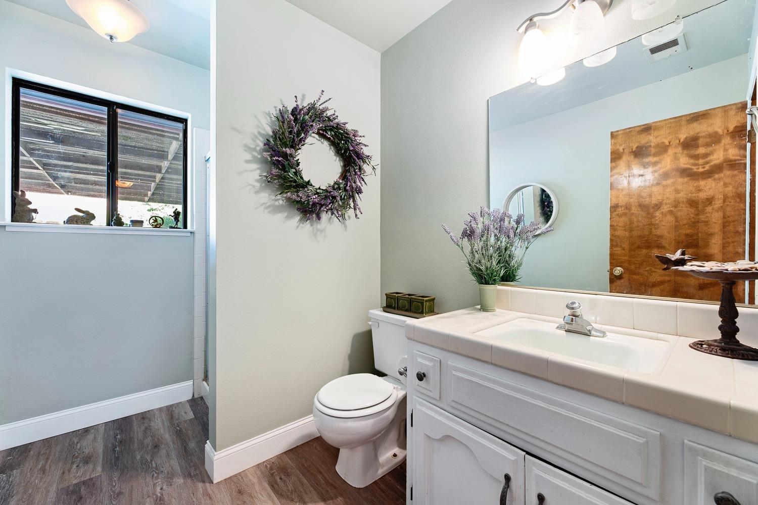 305 Monroe Street Coalinga, CA 93210 - Photo 28 of 53 a bathroom with a sink vanity mirror and toilet
