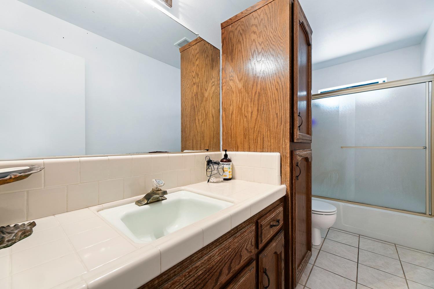 305 Monroe Street Coalinga, CA 93210 - Photo 30 of 53 a bathroom with a sink and a mirror