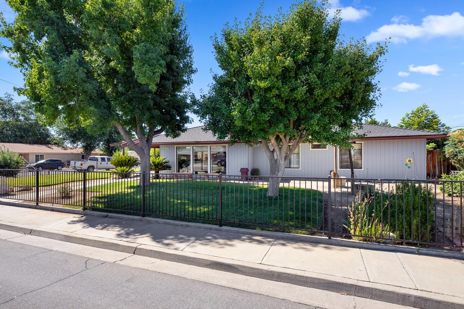 305 Monroe Street Coalinga, CA 93210 - Photo 3 of 53 a view of a house with a garden and pathway