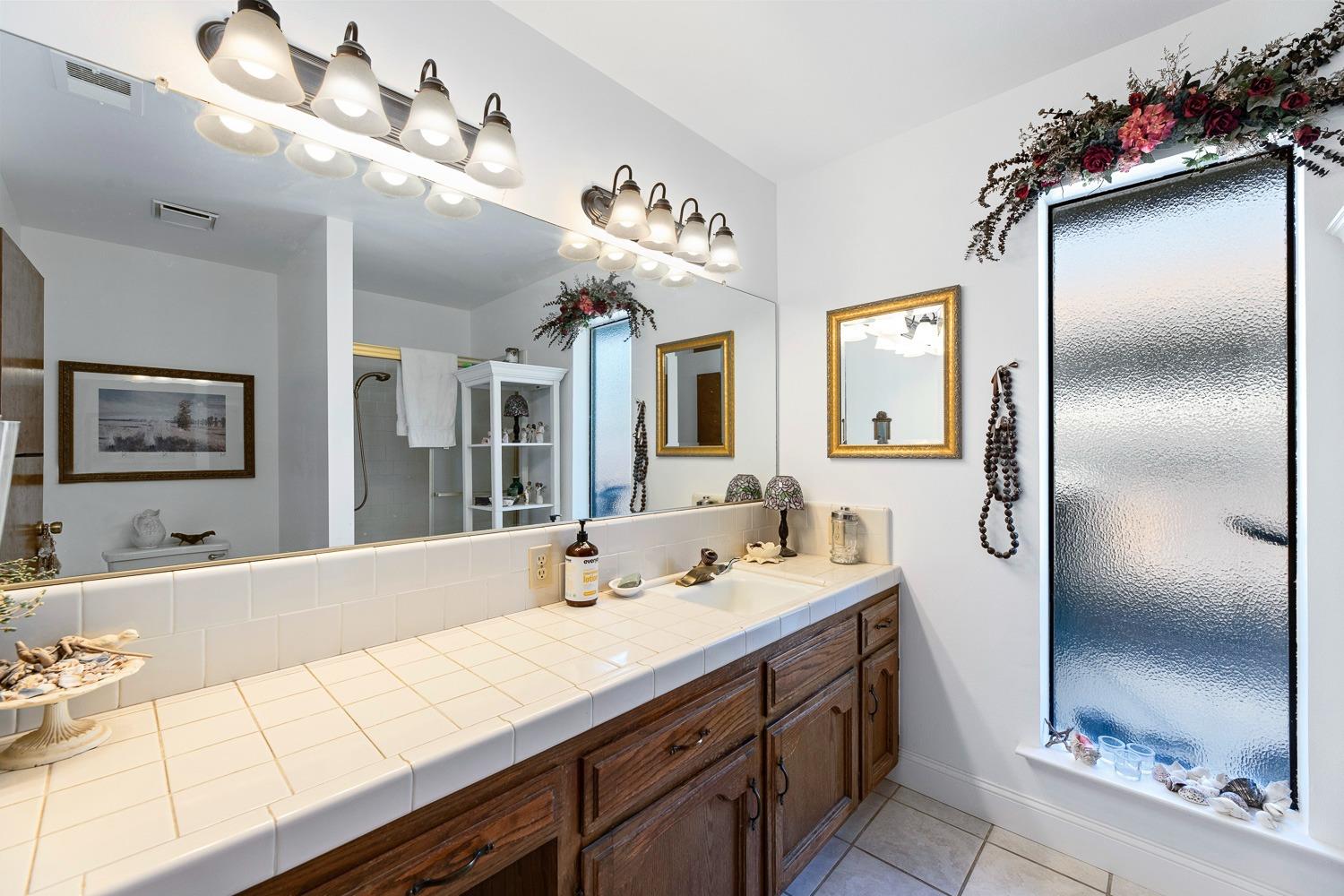305 Monroe Street Coalinga, CA 93210 - Photo 34 of 53 a bathroom with a sink double vanity and a mirror