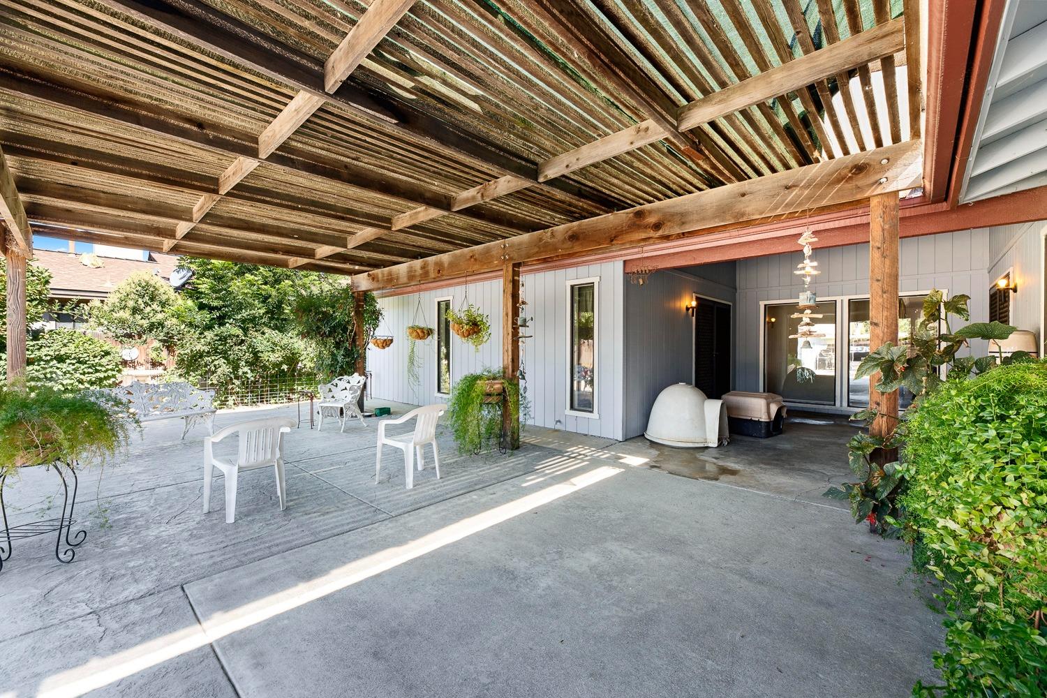 305 Monroe Street Coalinga, CA 93210 - Photo 35 of 53 a view of a patio with table and chairs and potted plants