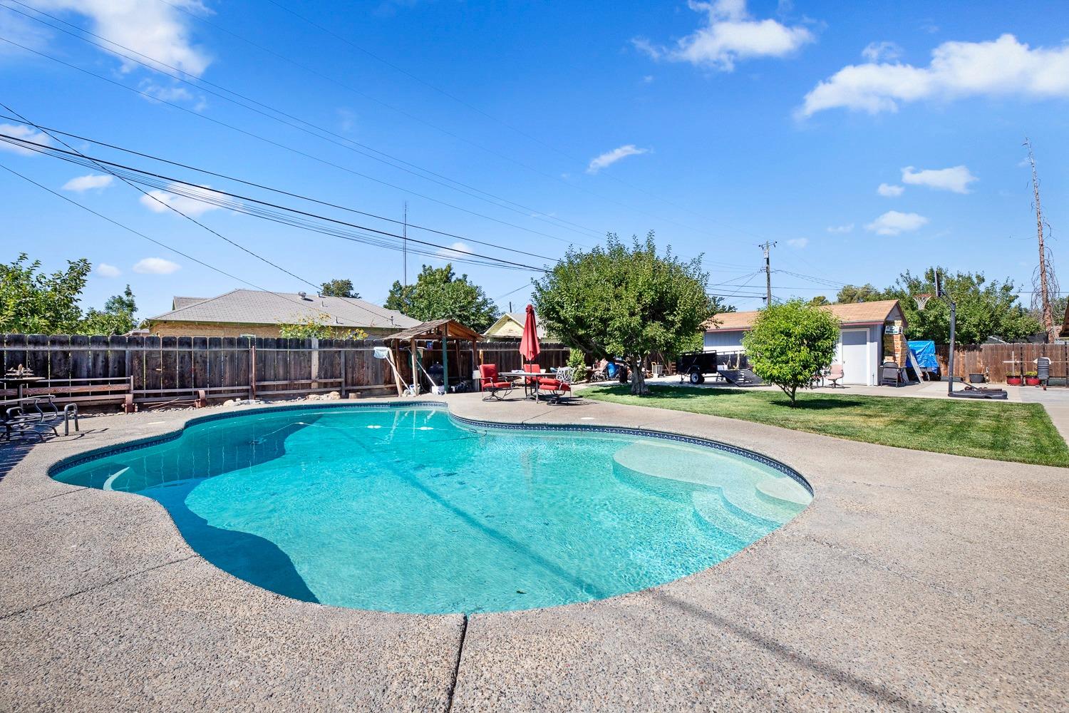 305 Monroe Street Coalinga, CA 93210 - Photo 42 of 53 a swimming pool with outdoor seating and yard