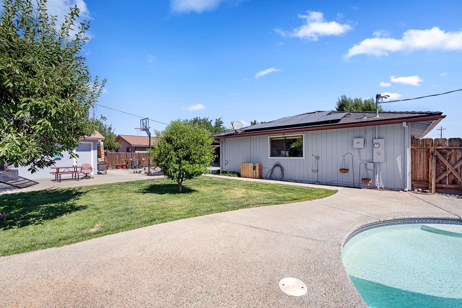 305 Monroe Street Coalinga, CA 93210 - Photo 43 of 53 a front view of a house with a yard and garage