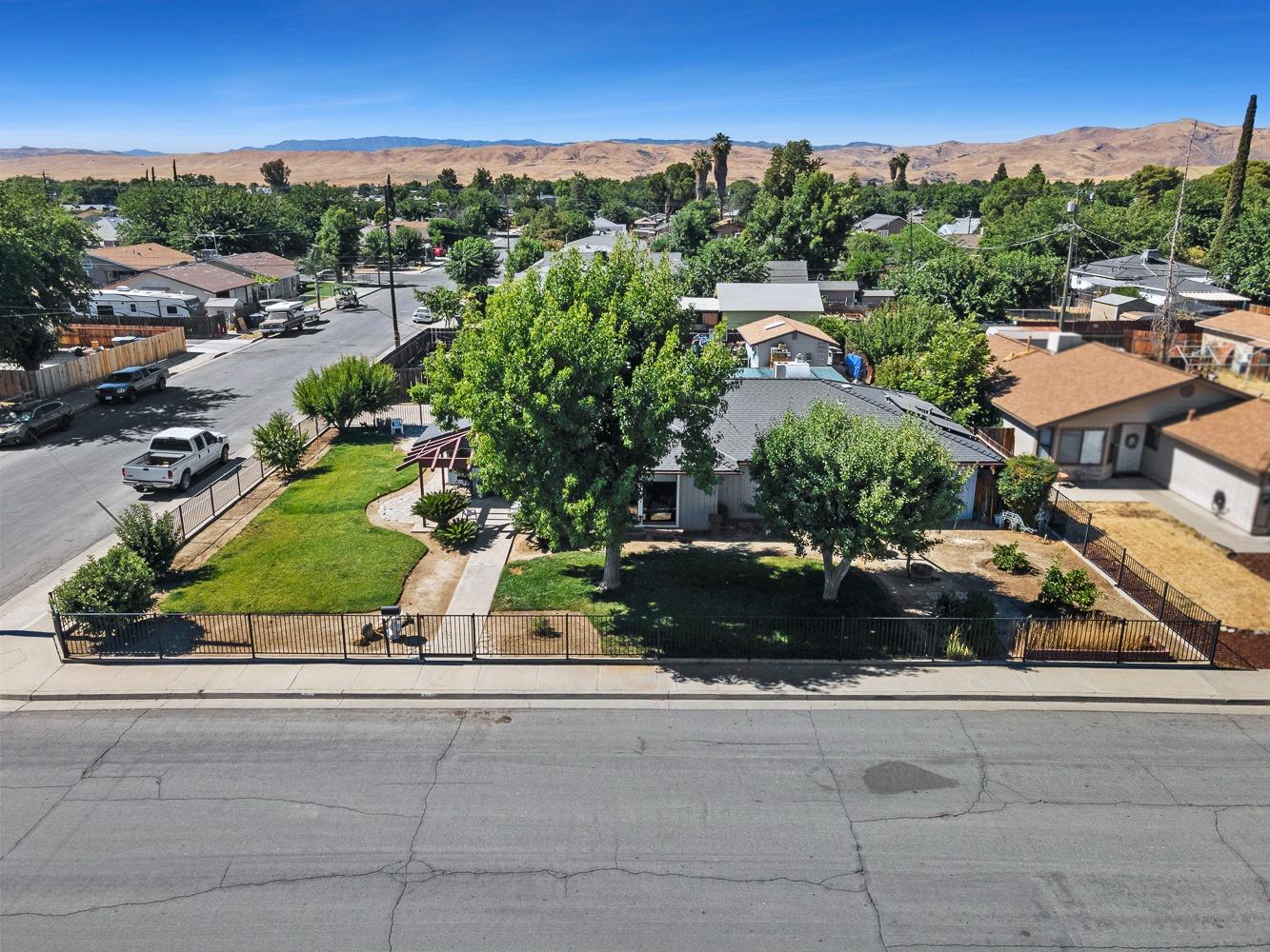 305 Monroe Street Coalinga, CA 93210 - Photo 44 of 53 an aerial view of multiple houses with a street