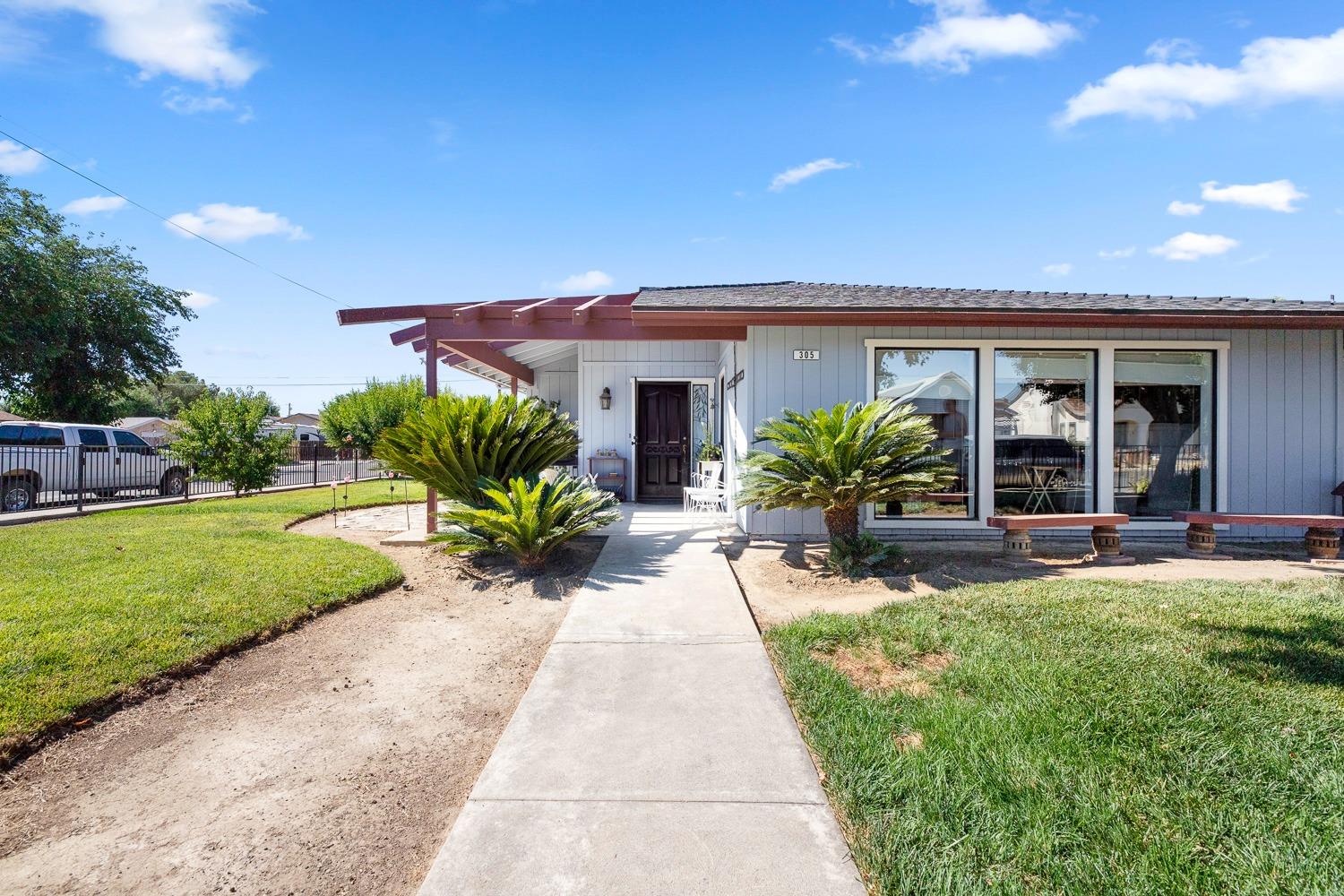 305 Monroe Street Coalinga, CA 93210 - Photo 6 of 53 a house view with a garden space