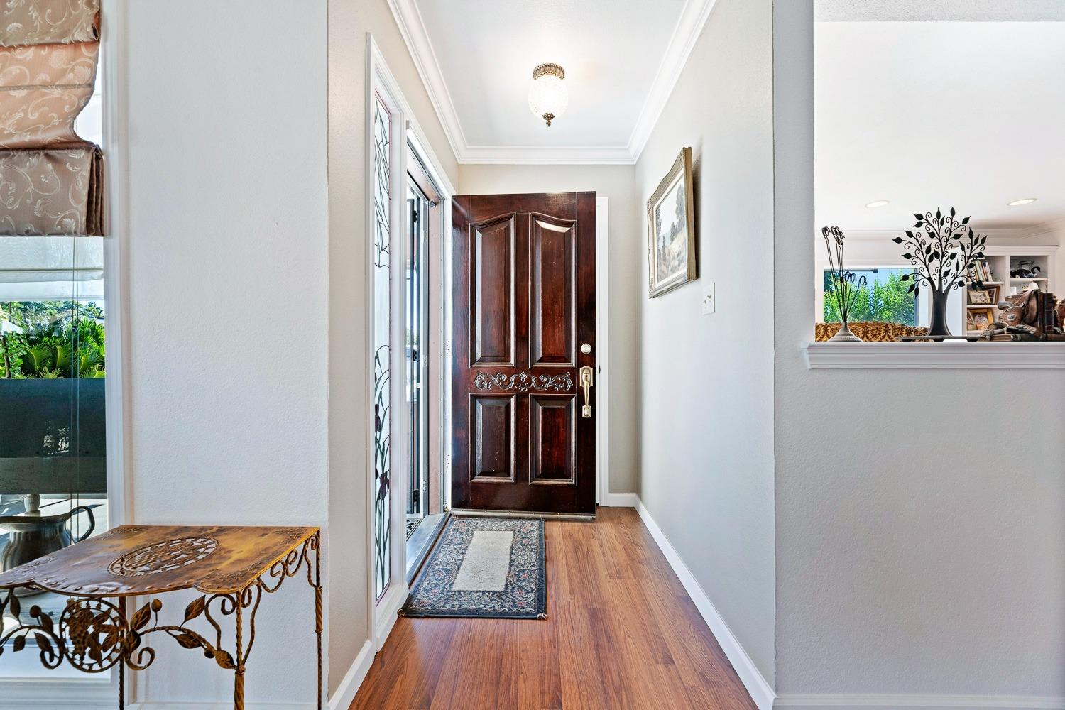 305 Monroe Street Coalinga, CA 93210 - Photo 8 of 53 a view of a hallway with furniture and wooden floor