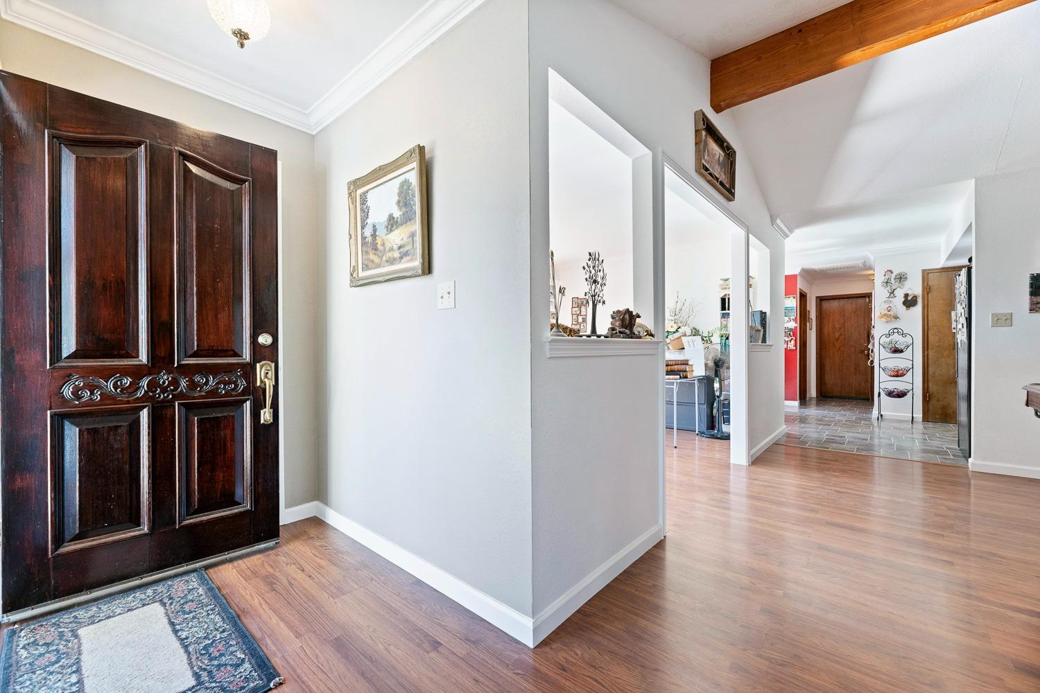 305 Monroe Street Coalinga, CA 93210 - Photo 10 of 53 a view of a hallway with wooden floor and windows
