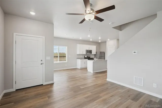 a view of kitchen with livingroom and wooden floor