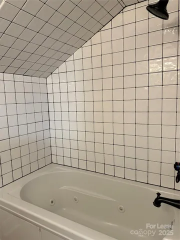 a bathroom with a bathtub and window
