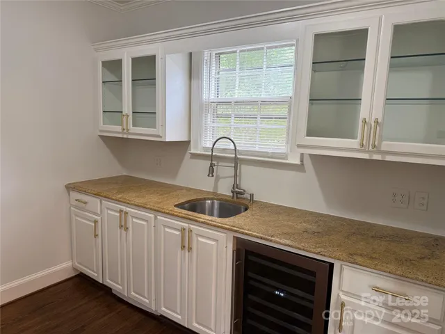 a kitchen with a sink and wooden cabinets