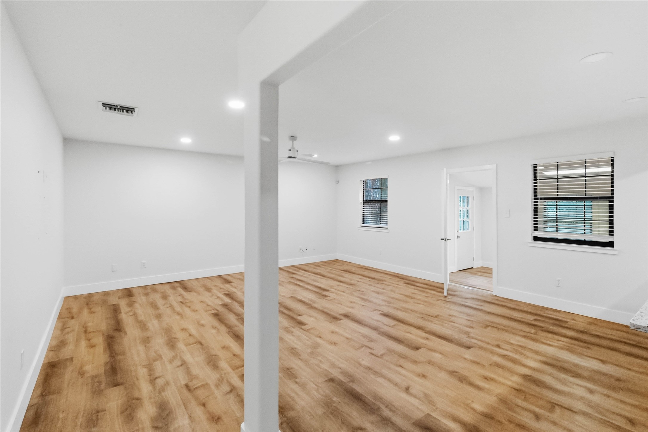 326 Pine View Loop Bastrop, TX 78602 - Photo 6 of 30 Natural wood flooring complements this generously proportioned living area, illuminated by recessed lighting.