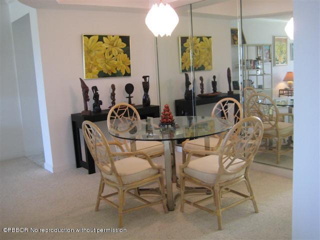 2175 Ibis Isle Road, Unit 4 Palm Beach, FL 33480 - Photo 4 of 9 a dining room with furniture and chandelier