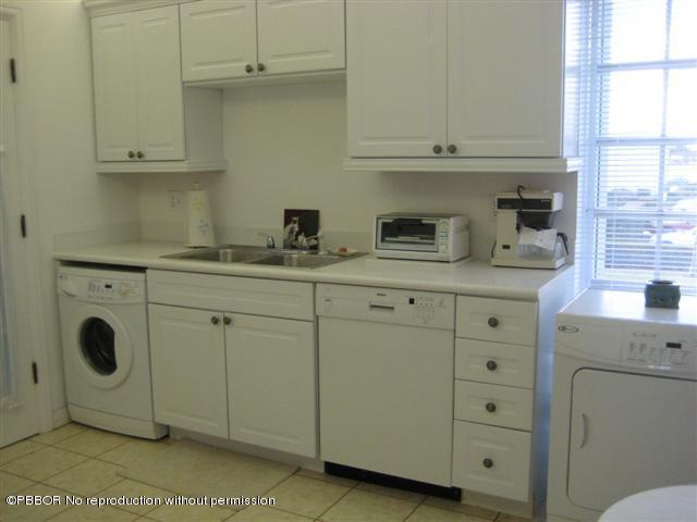 2175 Ibis Isle Road, Unit 4 Palm Beach, FL 33480 - Photo 5 of 9 a kitchen with cabinets appliances a sink and a window