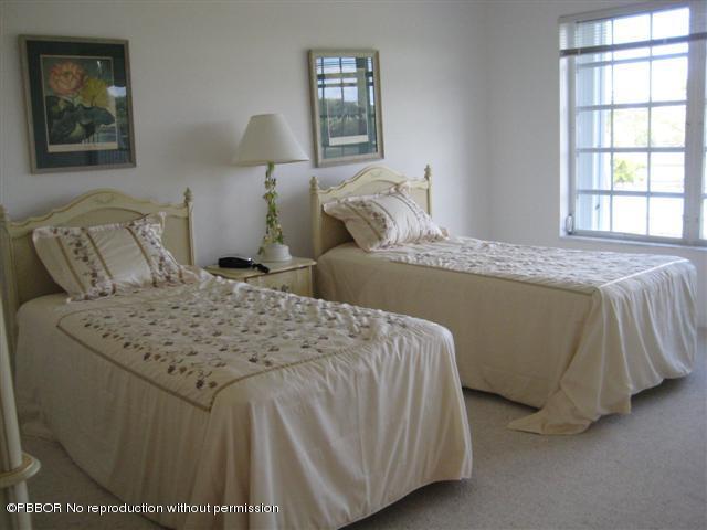 2175 Ibis Isle Road, Unit 4 Palm Beach, FL 33480 - Photo 6 of 9 a bedroom with a bed and a window