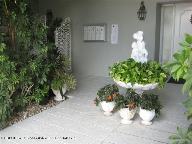 2175 Ibis Isle Road, Unit 4 Palm Beach, FL 33480 - Photo 8 of 9 a vase of flowers sitting on a floor