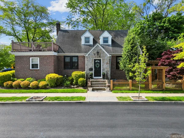 a front view of house with yard and green space