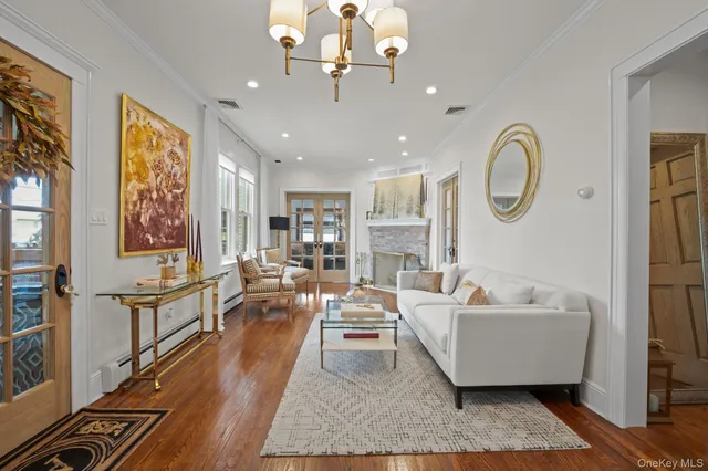 a living room with furniture and a chandelier