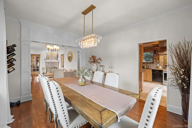 a view of a dining room with furniture wooden floor and chandelier