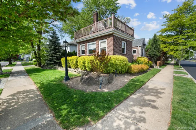 a front view of a house with garden and porch